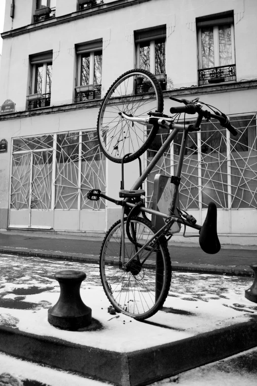 an old bike leaning up against the back of a pole