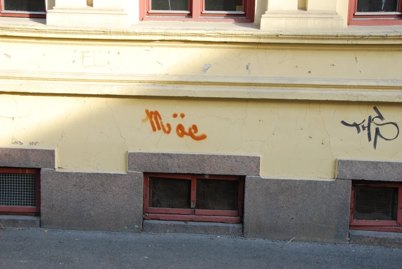 a cement building with graffiti writing on it