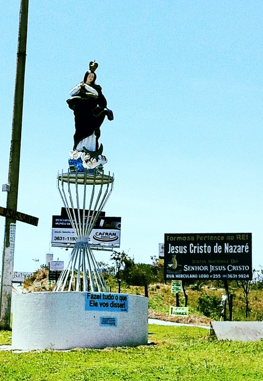 a statue sits in the center of a city park