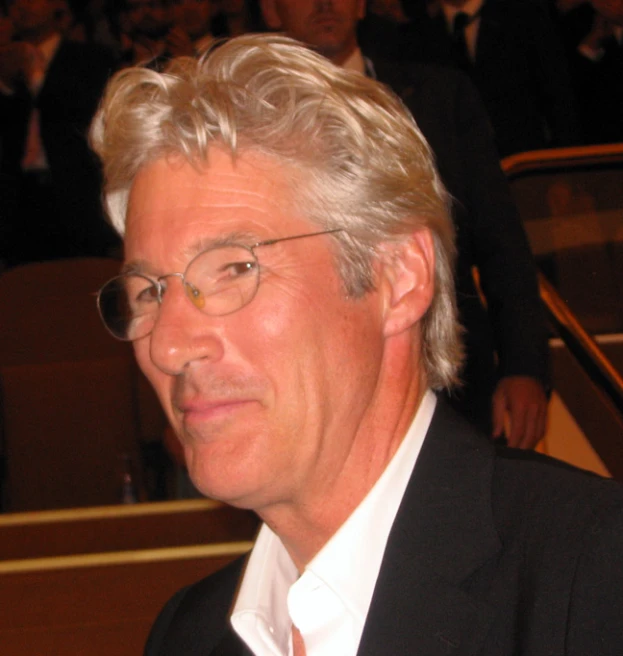 a man with glasses and a suit on