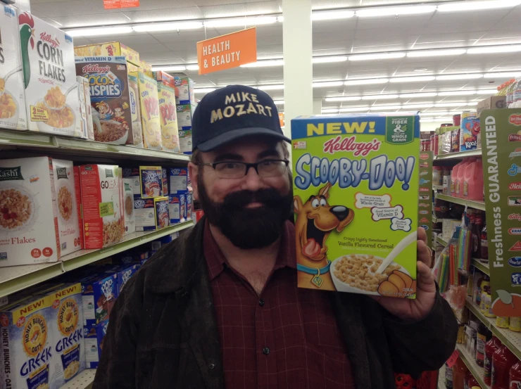 a man with a beard holding up his cereal package