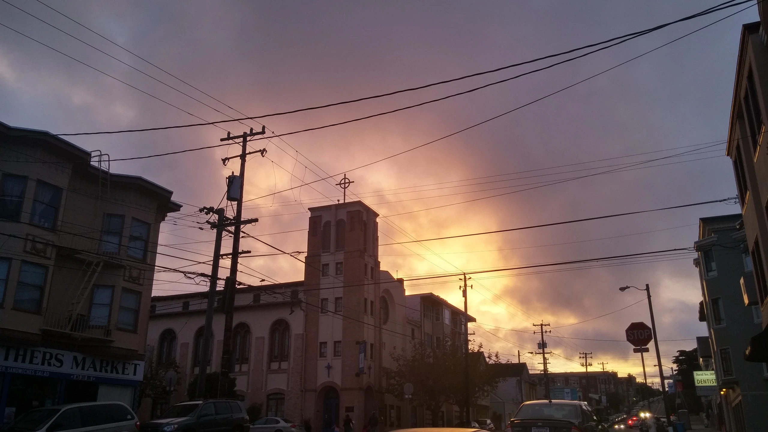 clouds gather over a building in the middle of a city