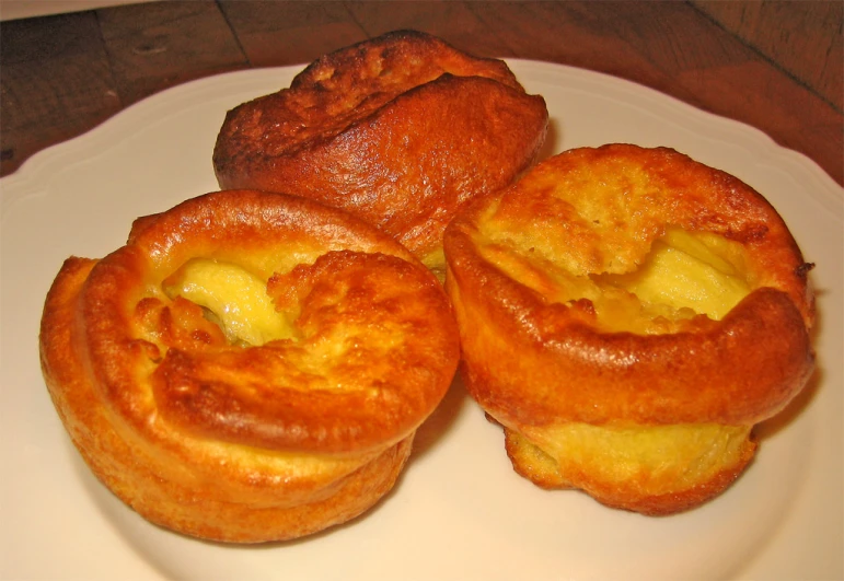 there are three mini cheese pastry on this white plate