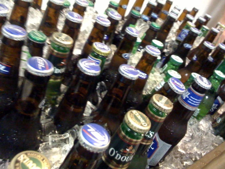 a table with lots of beer bottles stacked on top of each other