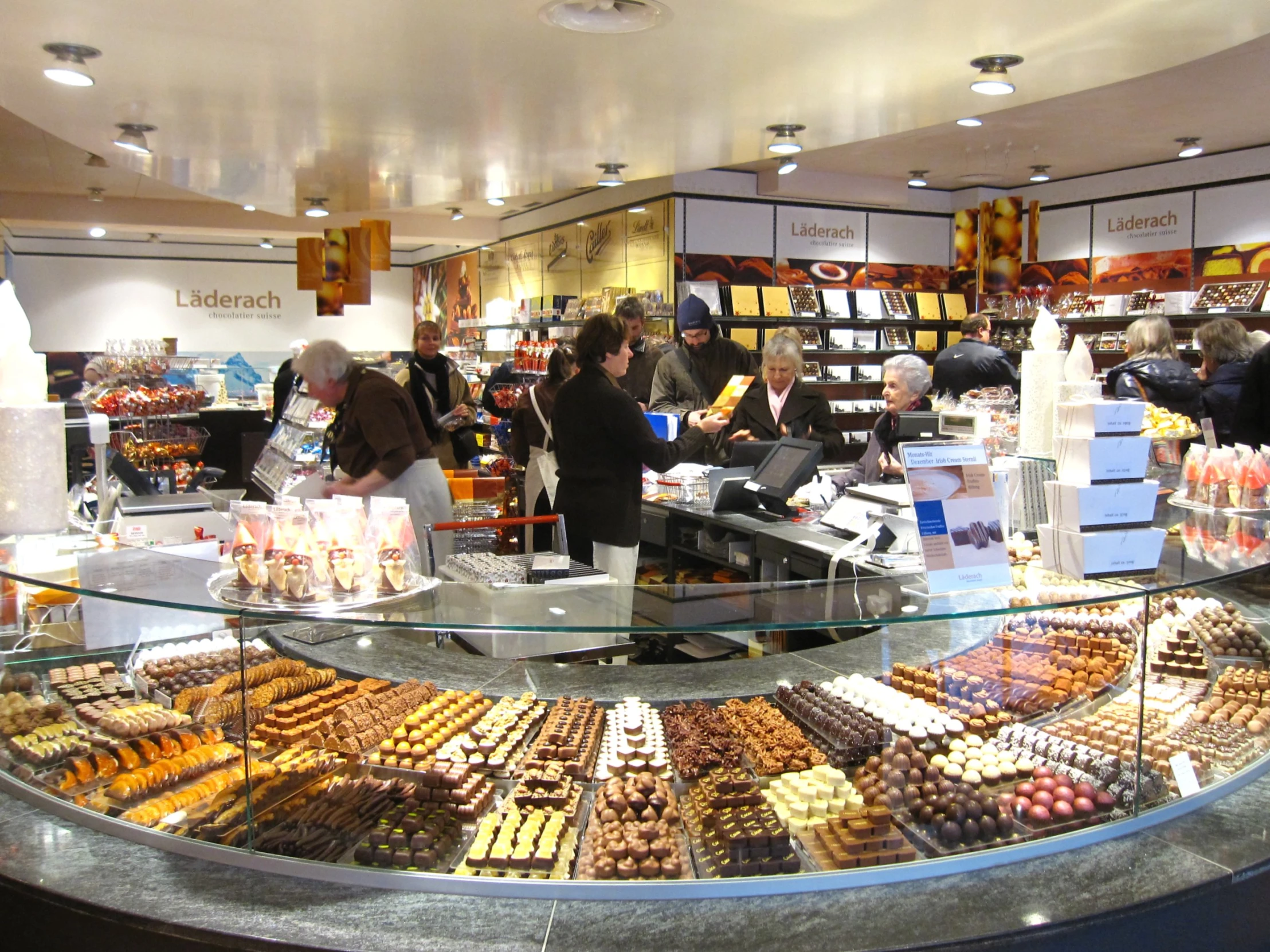 there are many desserts behind the counter at this bakery