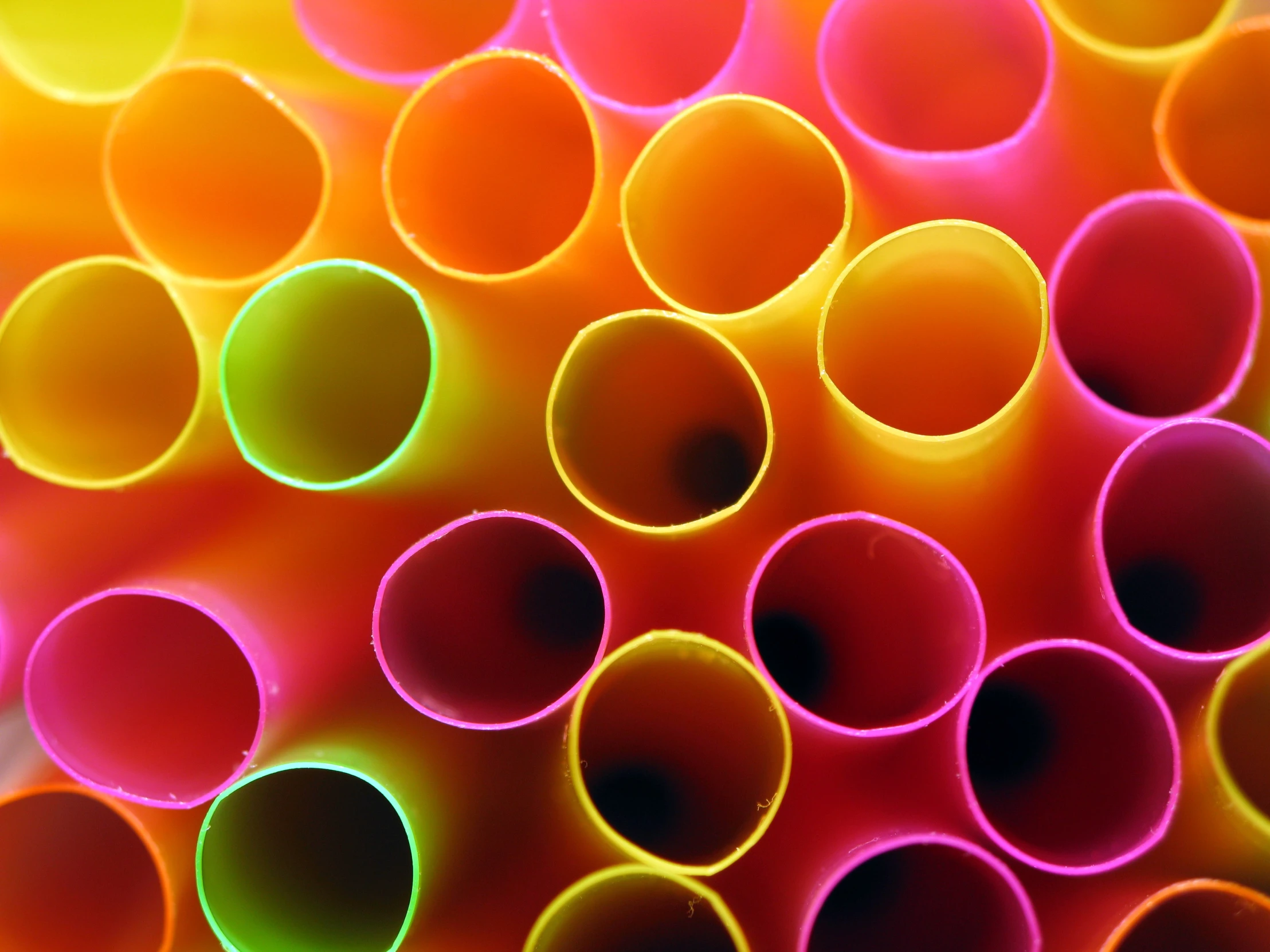 several different colored plastic tubes on a table