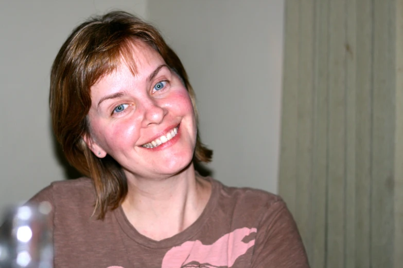 an image of a smiling woman with big blue eyes