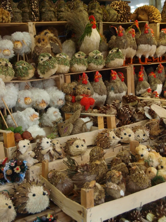 lots of stuffed animals and bird toys are piled up