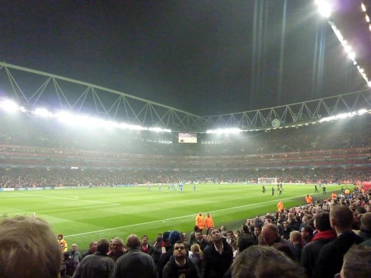 a stadium full of people watching a football match
