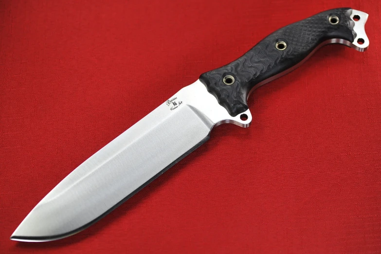 the black knife has gold accents and is made from leather