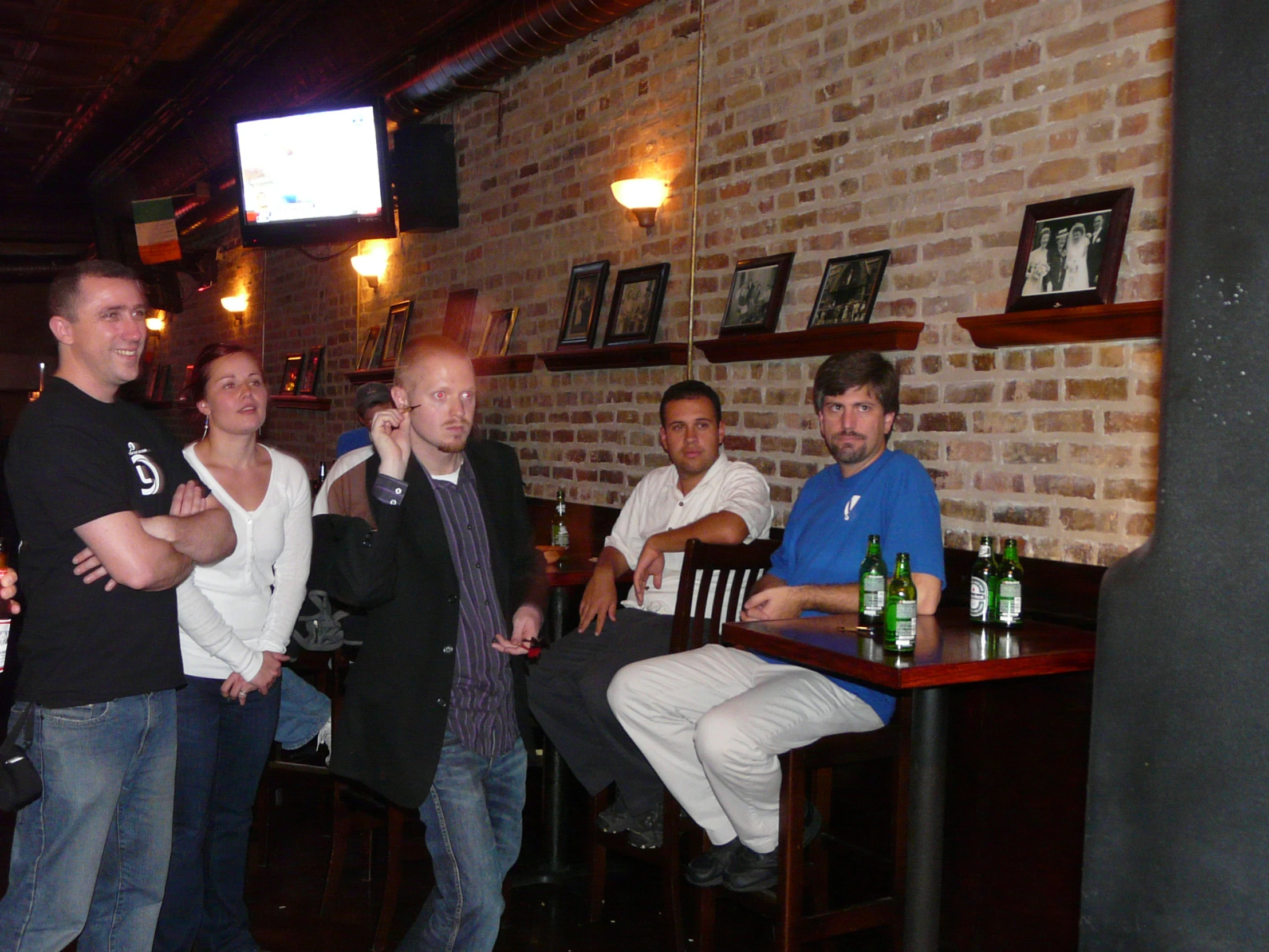 four guys posing for a po in a bar