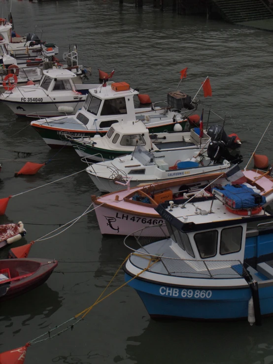 a group of boats tied up to the dock