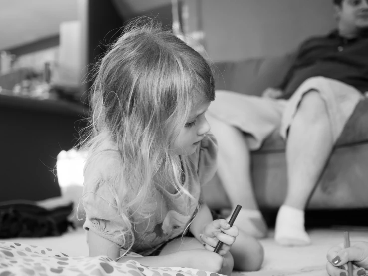 a girl is playing with an electronic device