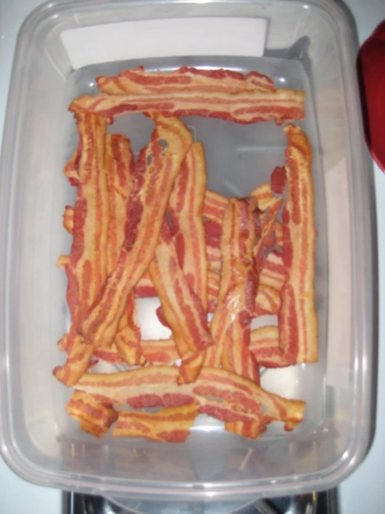 a bunch of bacon sitting in a container