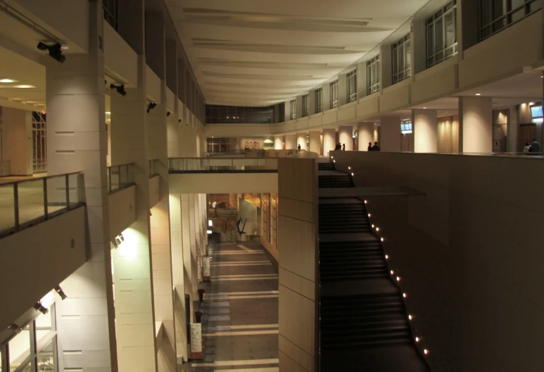 two people are walking through the hall of an office building