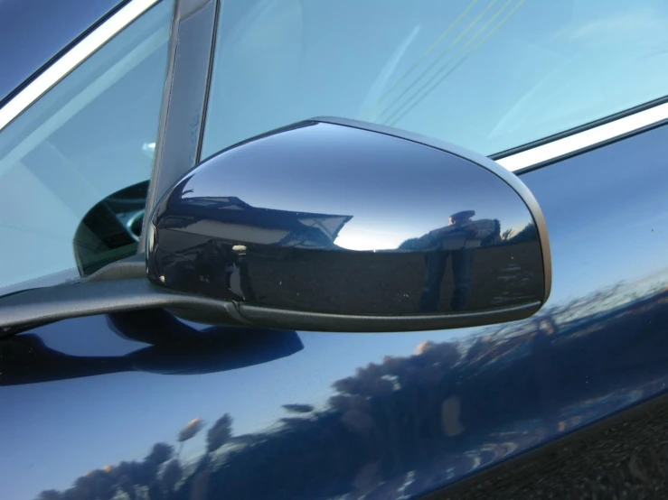 the view of a car through a side mirror