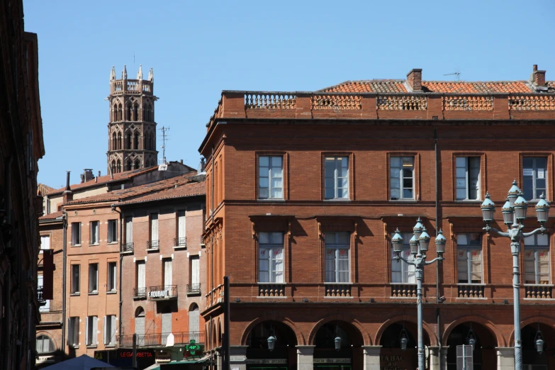 an old brick building with a clock tower in the background