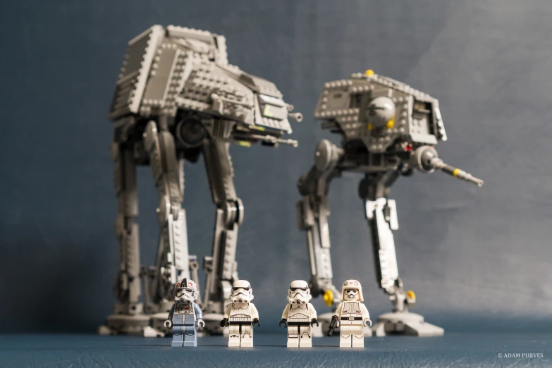 lego people standing around a lego at - at model
