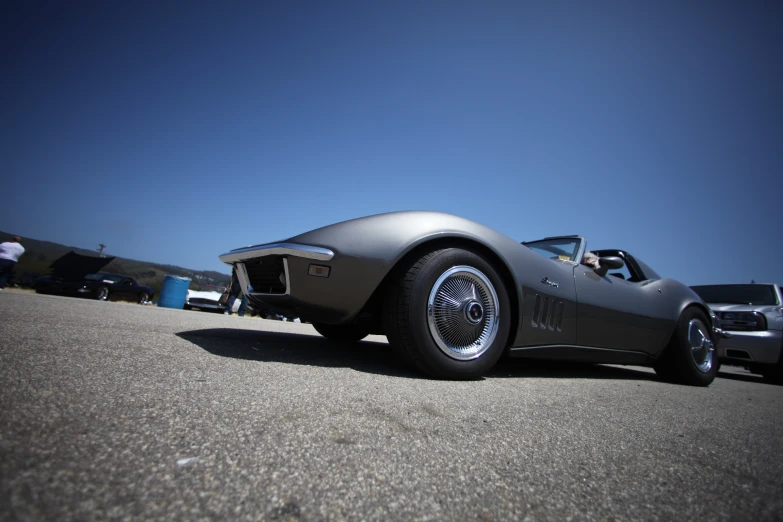 a grey sports car is parked on a parking lot