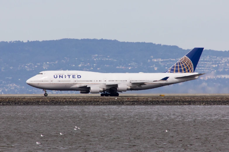 the united airlines plane is landing at the airport