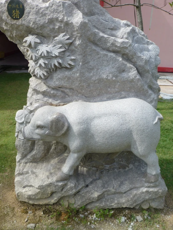 an animal statue standing next to a stone