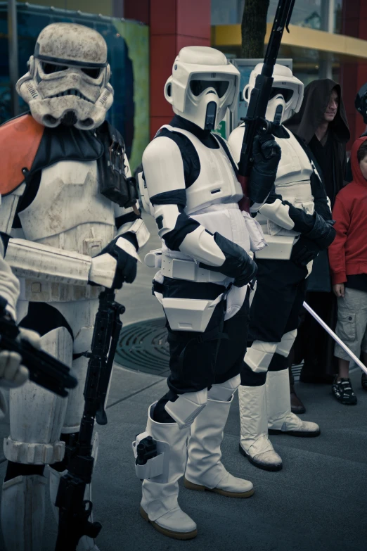 star wars cosplays holding guns standing next to each other