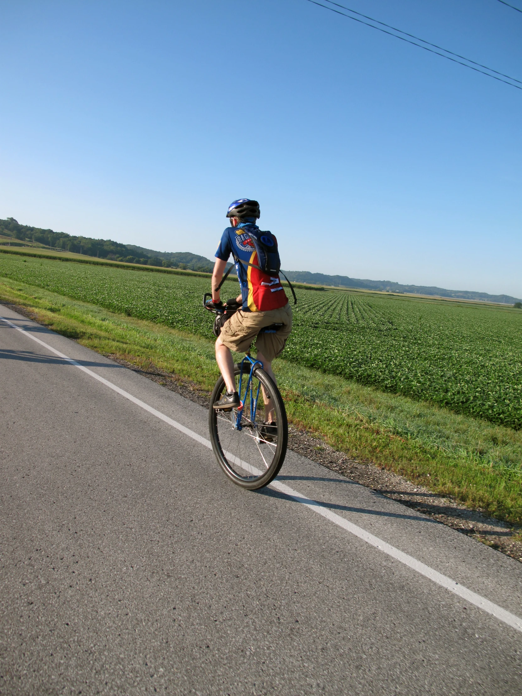 man on a bicycle going down the road