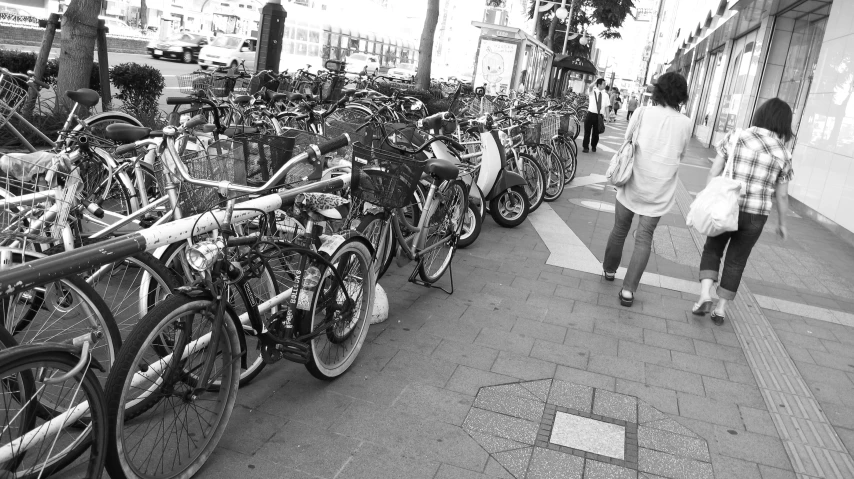 black and white image of a street full of bikes