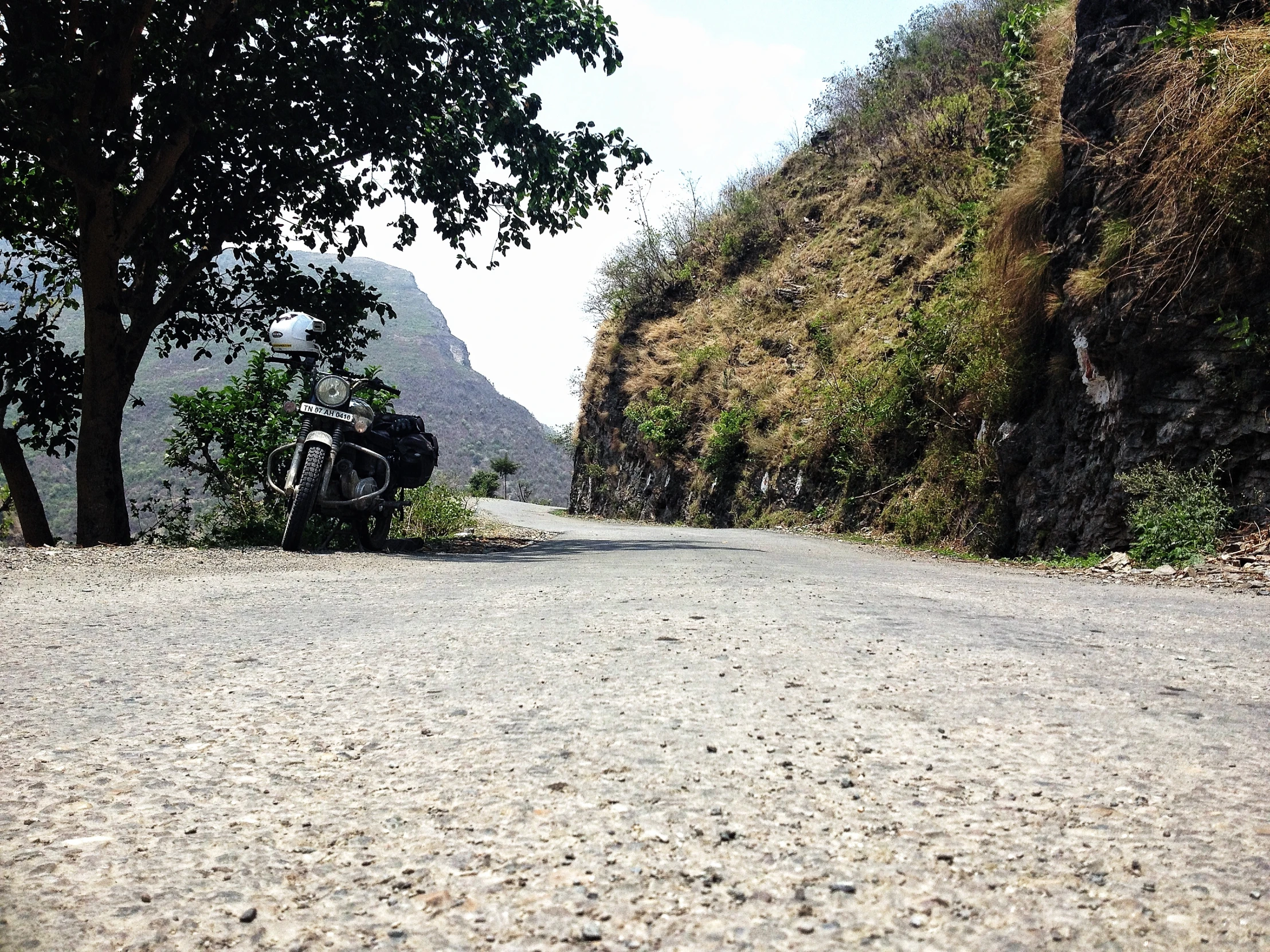 a long narrow road with a truck parked on the side