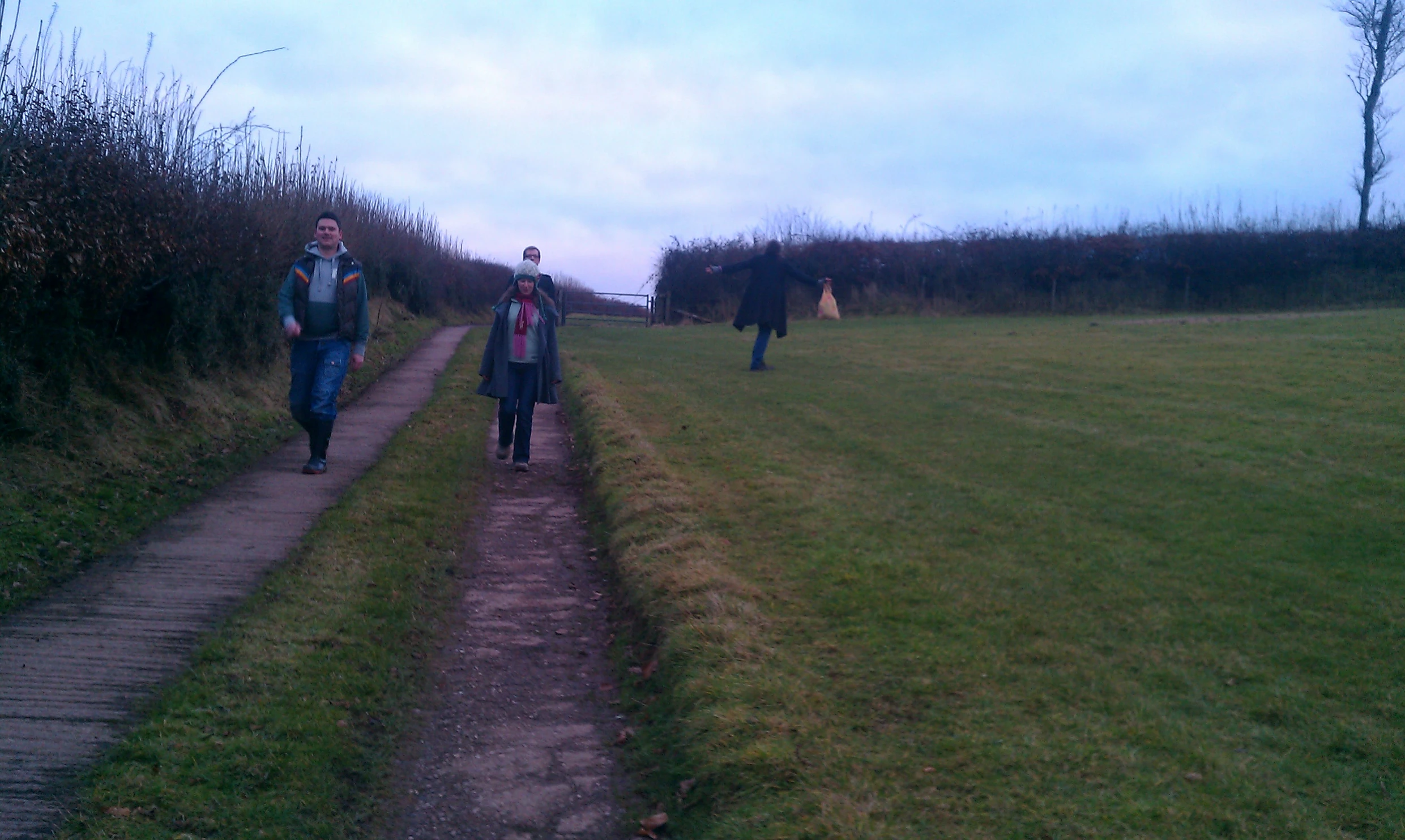 a group of people that are walking down a dirt path