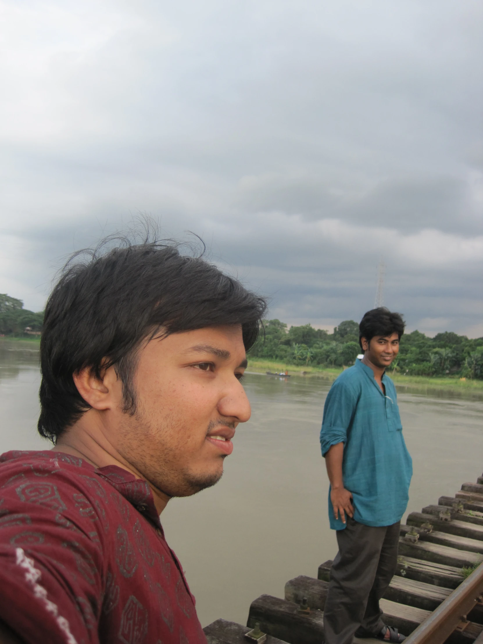 two men are on a wooden boat