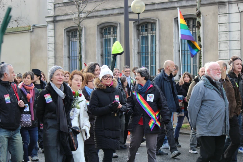 an image of many people that are standing in the street