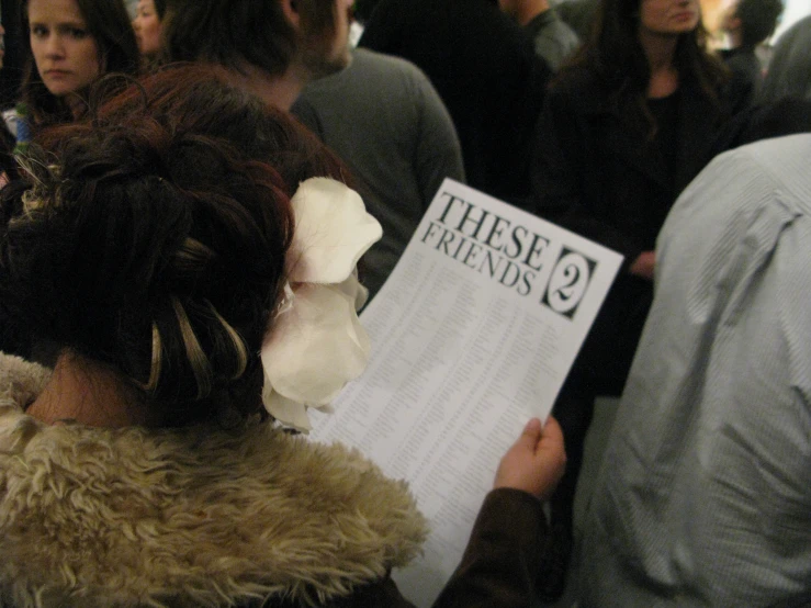 a woman holds a sign with the words these friends