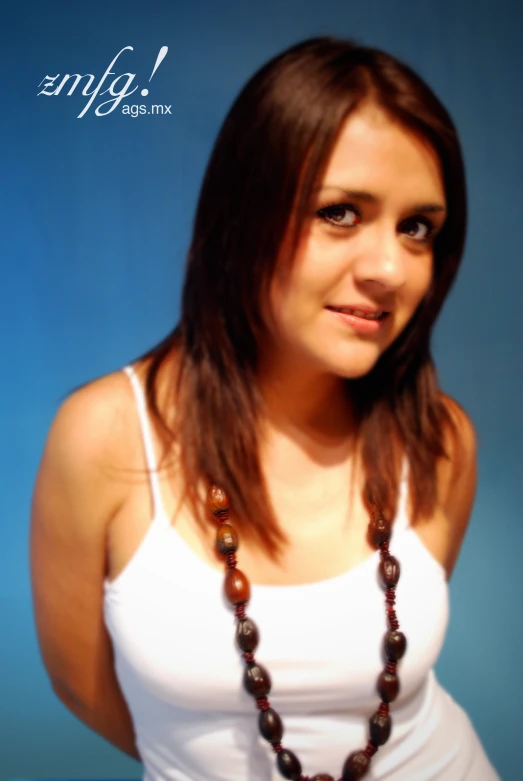 a woman that is standing in a white top and some beads