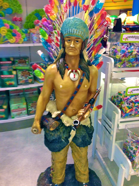 the statue is wearing an indian headdress and is in a store