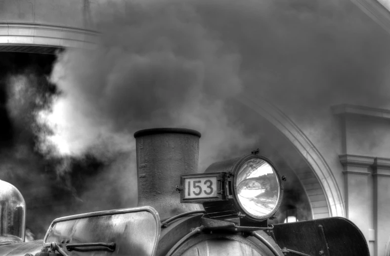 smoke and steam coming out of an old locomotive