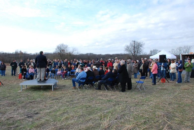 many people gathered together to hear a speaker