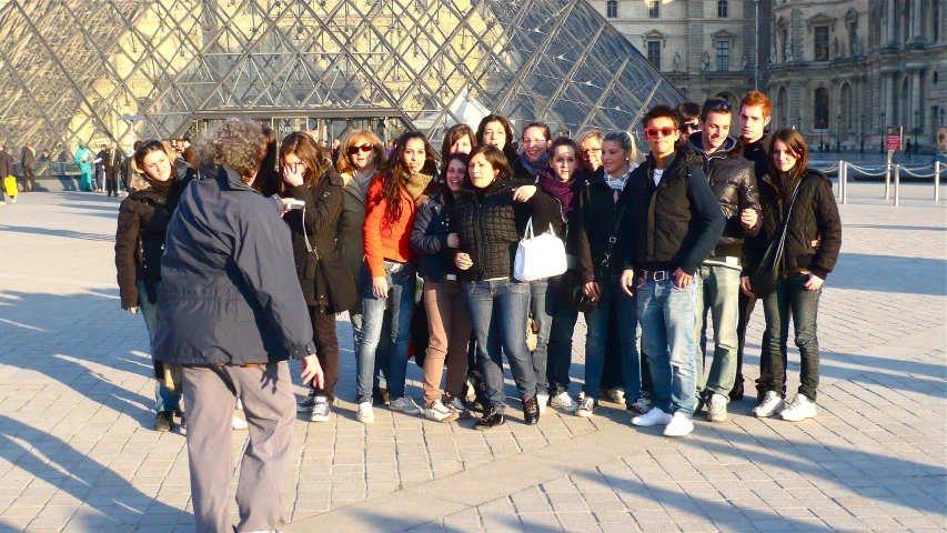 a group of people are posing for a picture