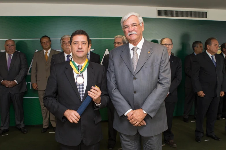 men in suits standing in front of other people