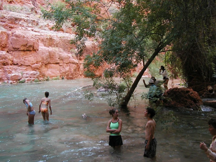 a group of people playing in a river