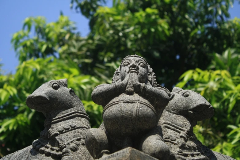 sculptures are displayed in front of some trees