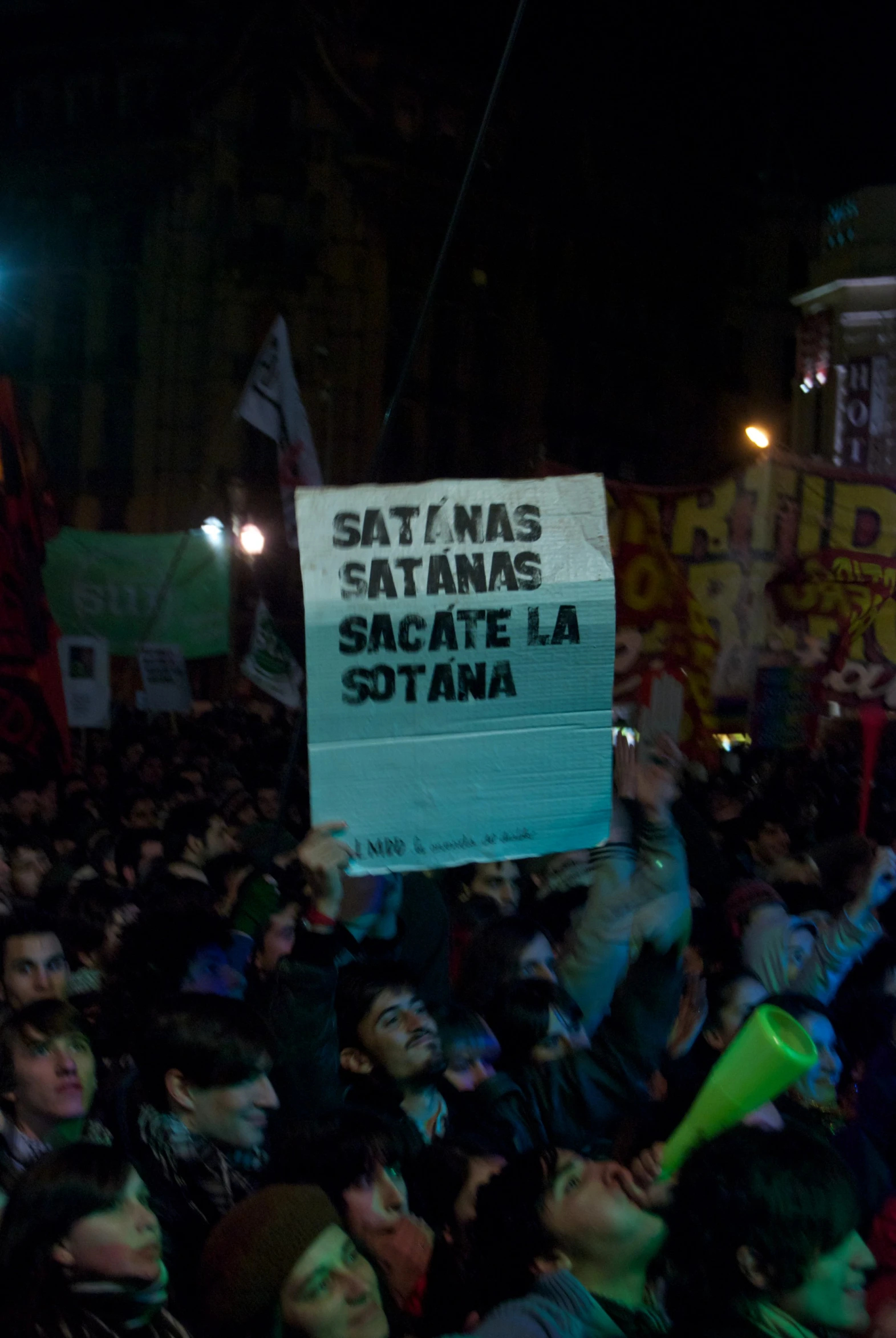 several people holding up a sign and some signs