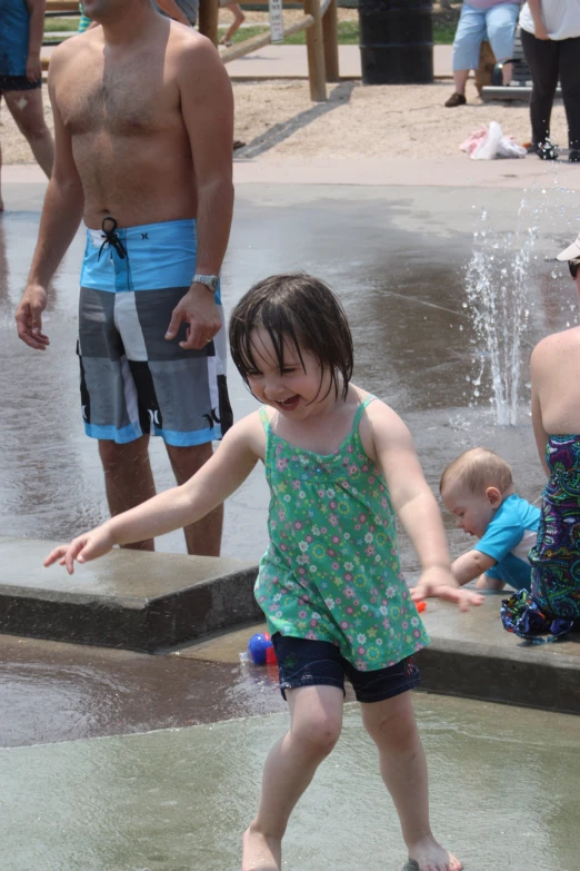 a  is playing in the water near the fountain