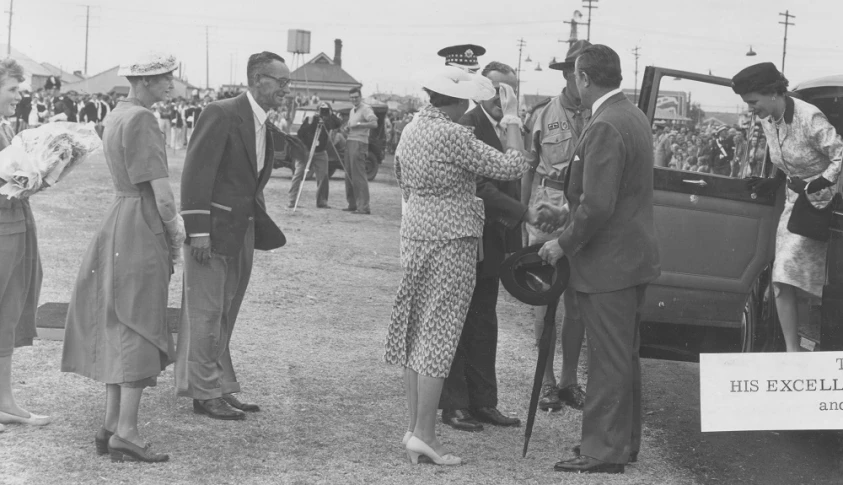 a vintage po shows men, women and boys about to get off the car