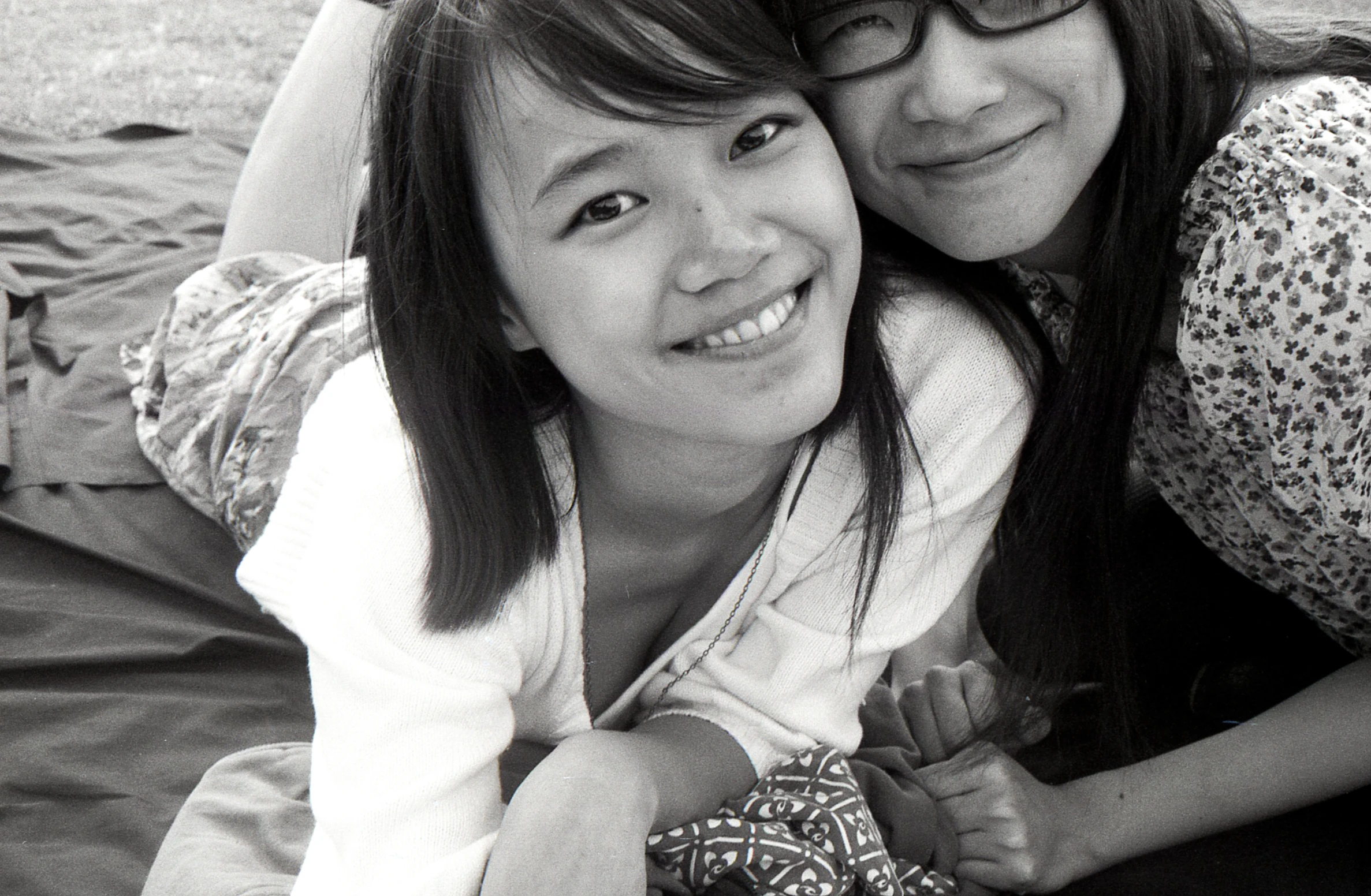 two women, both wearing glasses, pose for a po together