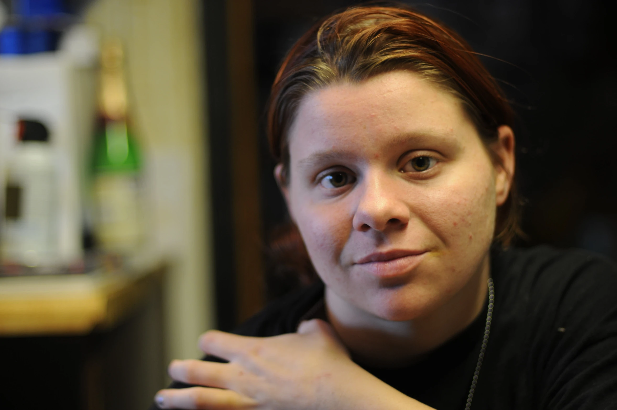 an attractive woman with a black shirt is looking forward