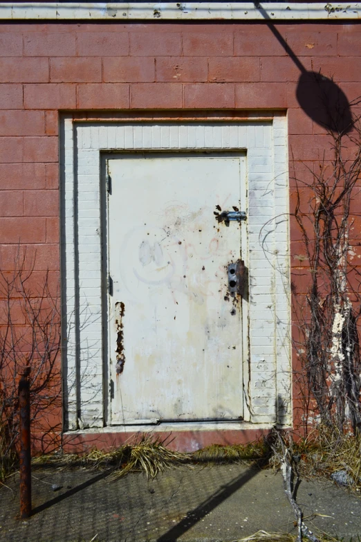 a door on an old brick building with graffiti
