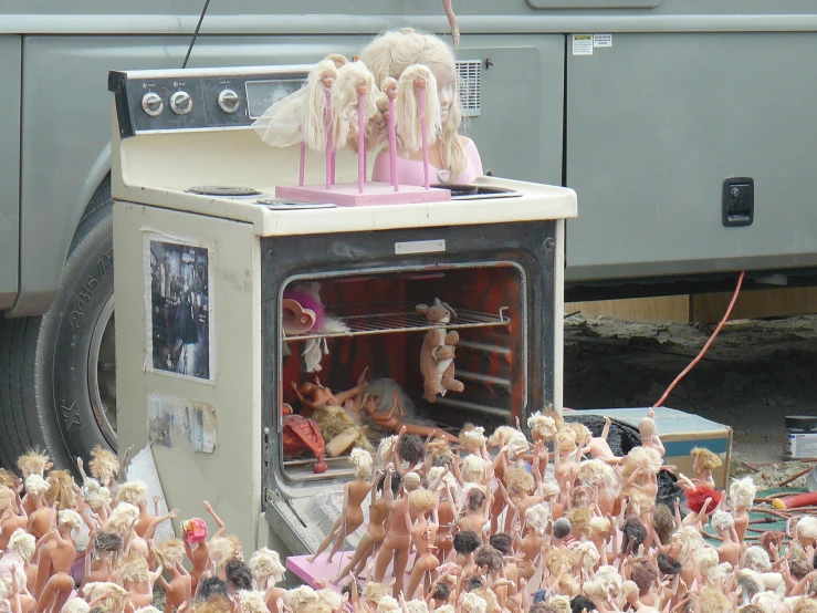 a bunch of dolls in the open on top of a stove