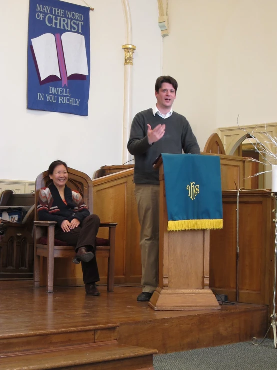 a man is standing at the podium talking