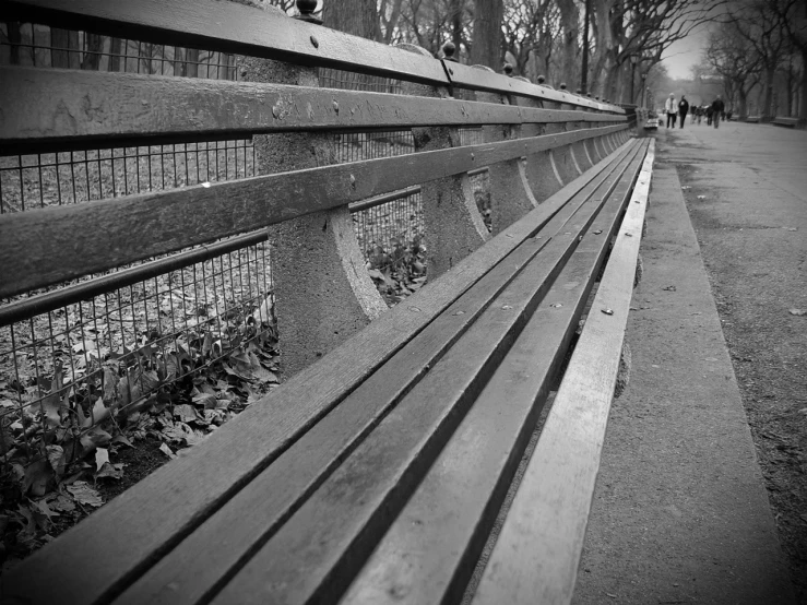 a close up of a long wooden bench